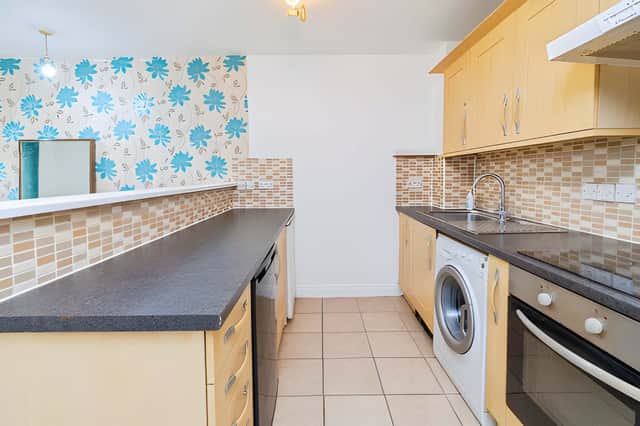 The large open-plan kitchen and dining room provides the apartment's main shared living space