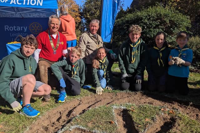 Rotary President Henry, Town Mayor Kevin Pugh and Ist Linslade Scouts planting crocus 