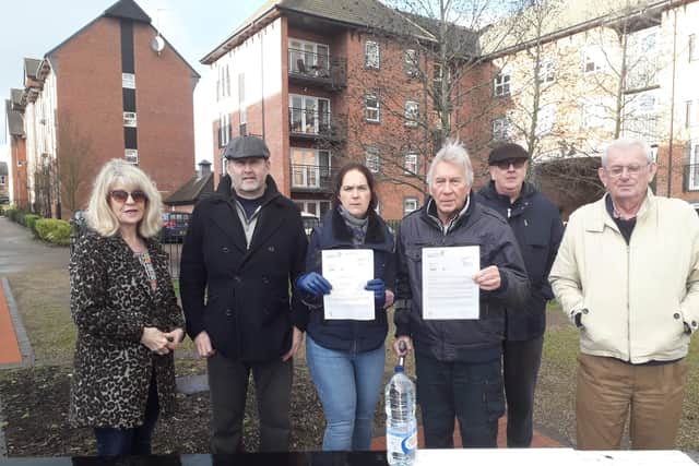 Residents of The Wharf (with Sam, middle) hold letters from AW which they received before Christmas. The letters explained the 12 hour compensation scheme. Credit: Sam.
