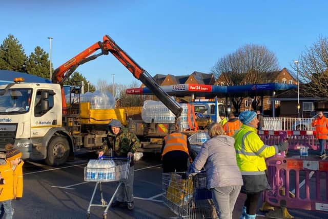 Residents collecting water at Tesco during the weekend of the water crisis. Credit: Branko Bjelobaba