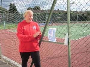 Linslade tennis club head coach Sara Bamford checking out one of their hand sanitiser stations