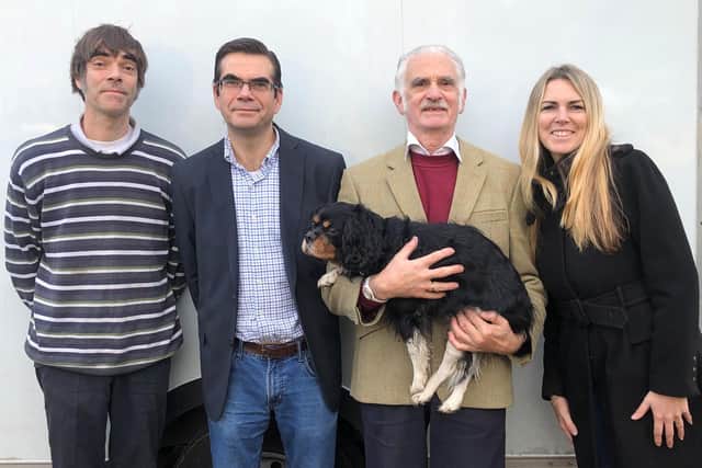 Tom with family members, including dog Nelson