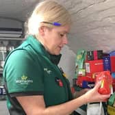 Katharine Smith, Morrisons Community Champion, helps to make food parcels.