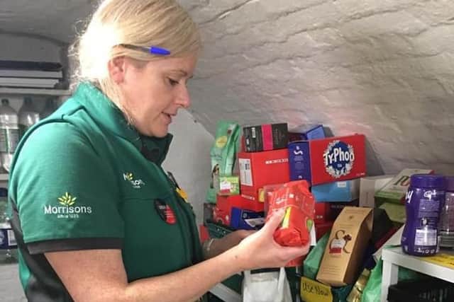 Katharine Smith, Morrisons Community Champion, helps to make food parcels.