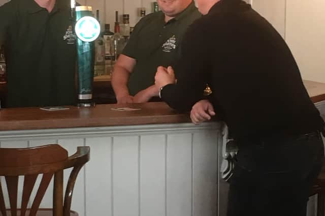 The Axe and Compass in happier times: Jake and Ryan Moxham film with cricketer Darren Gough. Credit: The Axe and Compass