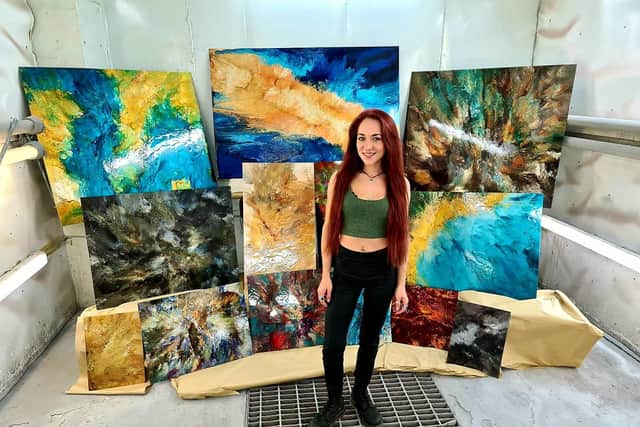 Claire with her artwork: "The colour, depth and detailed intricacy comes to life under bright light."