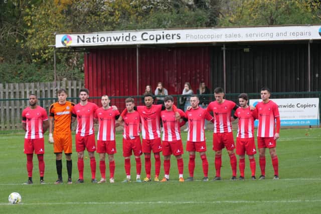 Leighton Town players line up for the minute's silence for Remembrance Day before Saturday's game