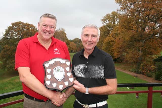 Club Captain Simon Rossiter (left) is presented with the match trophy by his successor, Graham Freer.