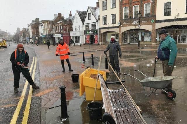 Councillors Harvey (left) and Morris (right) spread the grit on the High Street with volunteers in February 2021