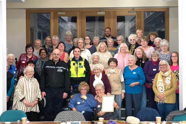 PCSO Carne presents Knit and Natter with their letter from the Prime Minister.