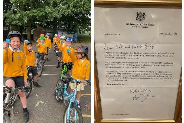 PCSO Carne has taught children their cycling proficiency skills and the ladies also made them pompoms with tags saying 'God Loves You'. Right: The Knit and Natter letter from the Prime Minister.