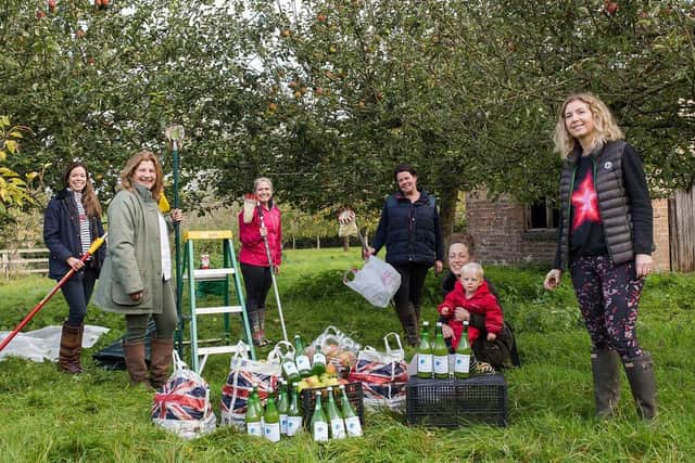 Grace (right) and members of her community were kept very busy collecting all the apples.