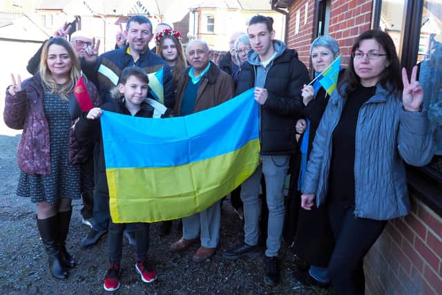 A group of Ukrainians proudly display the Ukrainian flag with Deputy Lord-Lieutenant Bedfordshire Vinod Tailor. Photo: Tony Margiocchi.