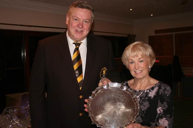 Anne Tilbury is presented with the Beck Trophy by Immediate Past Captain Simon Rossiter at Leighton Buzzard Golf Club