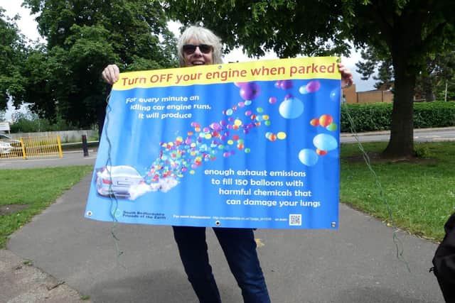 Christine Sheppard of South Beds Friends of the Earth with a banner