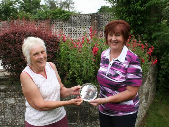 Lesley Brazier (right) receives the Buckmaster Salver from Ladies Captain Sandra Carter