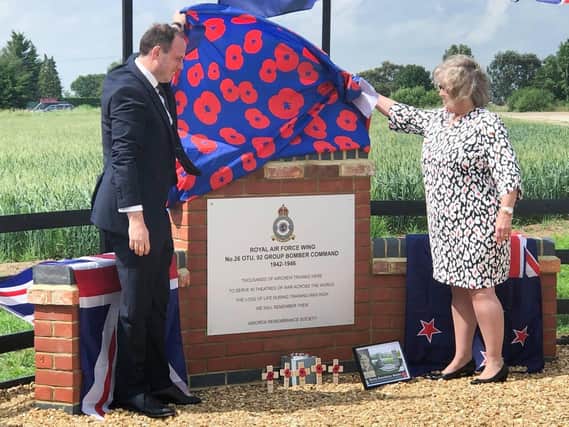 Greg Smith MP unveils the memorial assisted by Lynn Taylor-Overend, daughter of RAF Wing serviceman Eric Taylor,