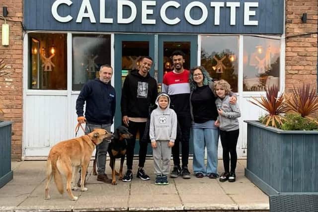 Frankie and his family with the duo who saved his young life, Kofi and Jermaine Reid reunited at the scene of the drama, Caldecotte Lake MK