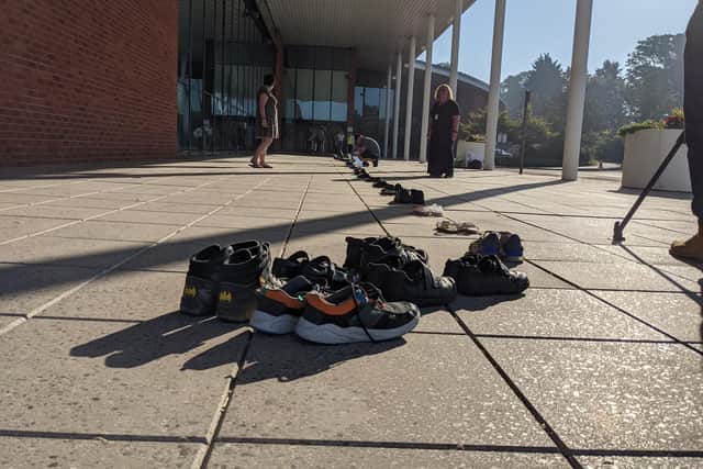 Parents placed 52 pairs of labelled children's shoes outside the entrance to Priory House - one to represent each child who has no suitable school place.