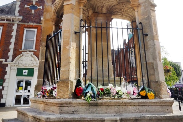 Flowers laid carefully at the Market Cross.