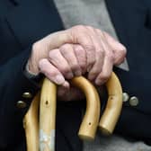 File photo of an elderly man holding a walking stick.