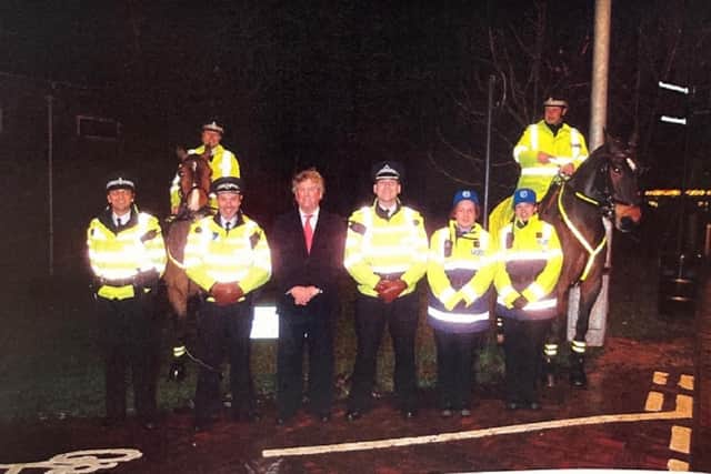 Adrian pictured with local police officers in Leighton Buzzard during the early 2000s.