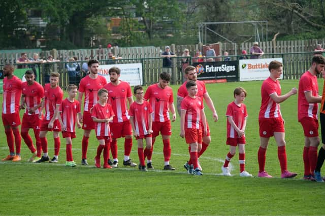 Players and mascots line up for the last home game of the season