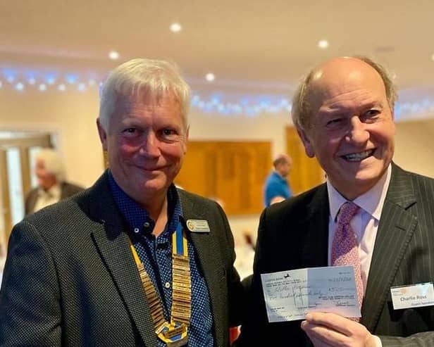 Rotary President Robin Comerford presenting Charlie Ross with a cheque for £500 in aid of Willen Hospice
