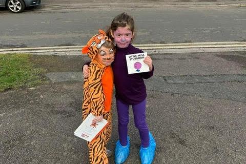 Chloe, aged three, as the Tiger Who Came To Tea, and Evie, five, as Little Miss Stubborn.