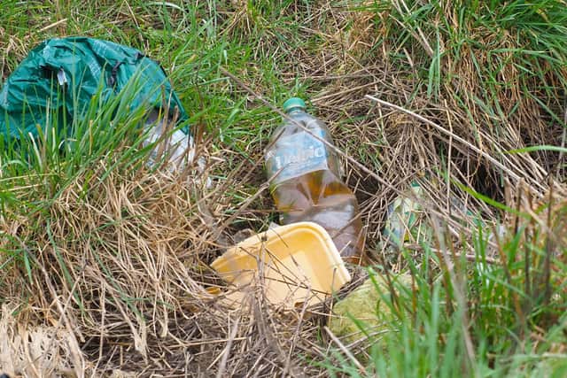 More ugly rubbish defacing our countryside - including an HGV driver's  suspicious looking pee  bottle. PIC: Tony Margiocchi
