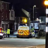 Police cordon and cars around the scene. Picture: Chris Keen