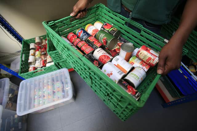 Tins of food in a basket at a  Trussell Trust foodbank