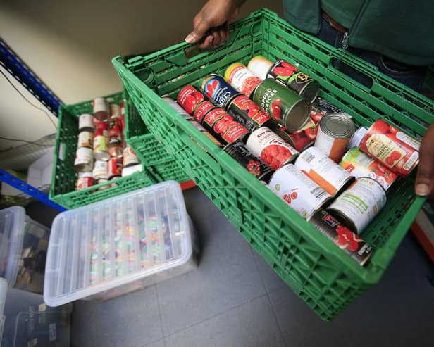 Tins of food in a basket at a  Trussell Trust foodbank