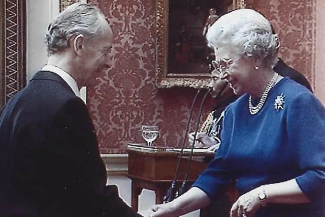 Russell receiving his OBE from the Queen. Photo: Russell Stannard.
