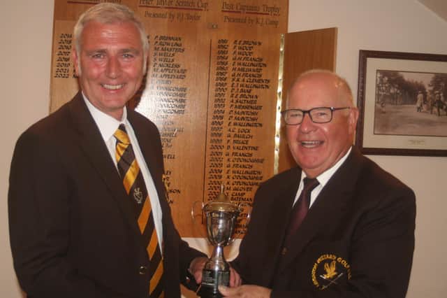 Graham Freer (left) receives his trophy from club president Trevor Stimpson.