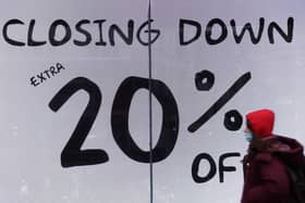 File photo of a closing down sign in a shop window (Photo by HOLLIE ADAMS/AFP via Getty Images)