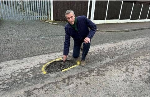 South West Bedfordshire MP next to a pothole. Picture: Andrew Selous