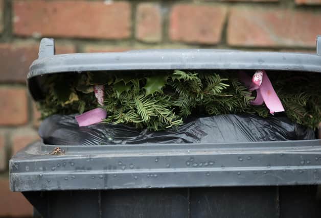 Christmas decorations sit on top of rubbish in a bin waiting to be collected.  (Photo by Matt Cardy/Getty Images)