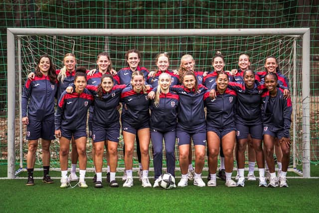 Tricia is pictured second from right on the back row