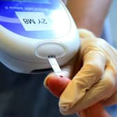 A nurse giving a patient a diabetes test