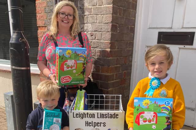 Two of the boys and their mum pictured with the gifts. Image: Leighton Linslade Helpers.