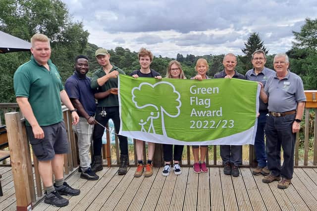 The Rushmere Country Park team raises the green flag with pride. Image: The Greensand Trust.