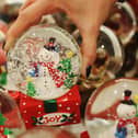 File image of a person picking up a Christmas snowglobe.  (Photo by Dan Kitwood/Getty Images)