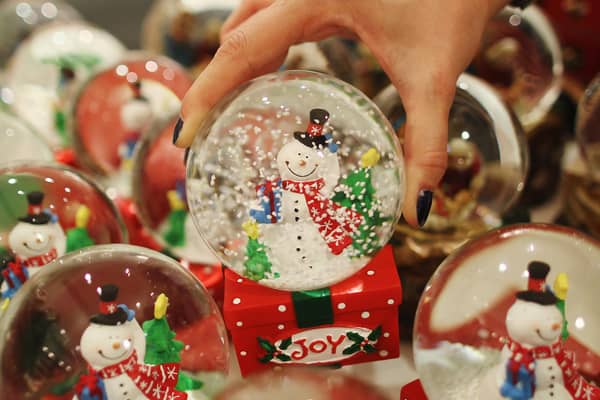 File image of a person picking up a Christmas snowglobe.  (Photo by Dan Kitwood/Getty Images)