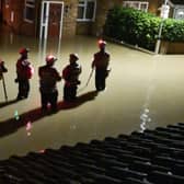 Emergency workers standing in flood water during the recent Central Bedfordshire floods. Picture: Debbie Ward