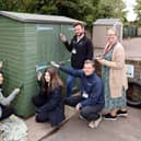 Volunteers from Barratt David Wilson Homes painting the sheds