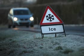 A warning triangle alerts drivers to an icy road (Photo by Christopher Furlong/Getty Images)