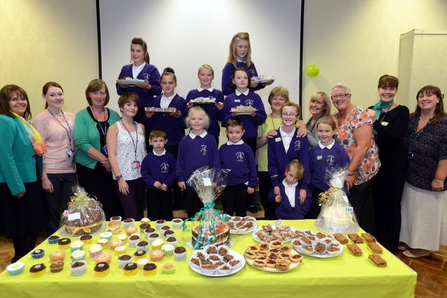 Staff and pupils at Hastings Hill Academy who raised over £600 during the Macmilan Worlds Biggest Coffee Morning 9 years ago.