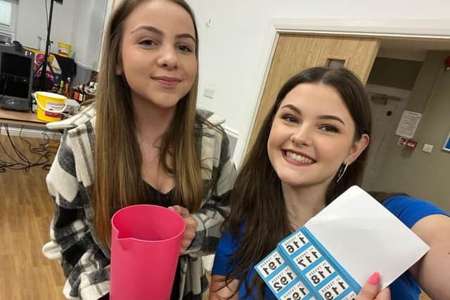 Emily's daughter, Maisie, left, and Simon's daughter, Becki, selling raffle tickets at the race night fundraiser
