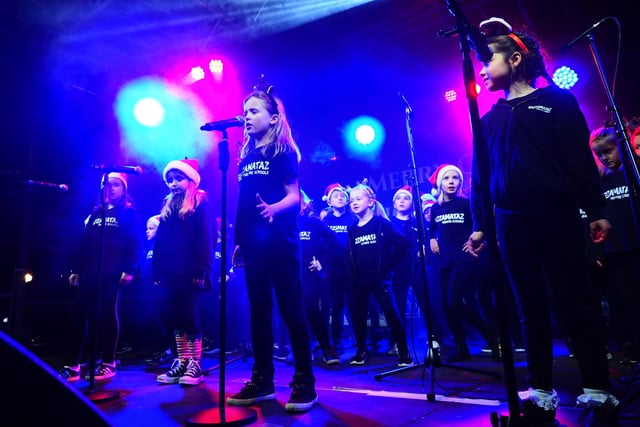Youngsters sing Christmas songs to get everyone into the festive spirit.
